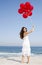 Beautiful girl holding red ballons