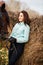 Beautiful girl with horse outdoors