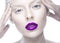 Beautiful girl in the image of albino with purple lips and white eyes. Art beauty face.