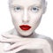 Beautiful girl in the image of albino with red lips and white eyes. Art beauty face.