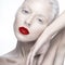 Beautiful girl in the image of albino with red lips and white eyes. Art beauty face.