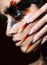 Beautiful girl in image of Phoenix bird with creative makeup and long nails. Manicure design. beauty face.