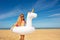 Beautiful girl with inflatable buoy on sand beach