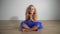Beautiful girl kid sitting on floor at home relax. Yoga concept. Gimbal movement