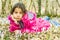 Beautiful girl laying in the flowers in the forest