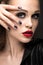 Beautiful girl in leather jacket with bright makeup and manicure Cat\'s Eye. Beauty face. Nail Design.