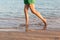 Beautiful girl legs running on the beach. pretty girl walking on water