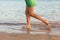 Beautiful girl legs running on the beach. pretty girl walking on water