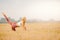 Beautiful girl with long blonde hair in sportswear is stretching in park field sunrise. Health Benefit Yoga Concept