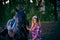 Beautiful girl with long hair on a walk with a horse.