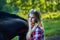 Beautiful girl with long hair on a walk with a horse.