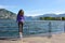 Beautiful girl looking lake and mountains sunny landscape on background outdoor. Travel healthy lifestyle concept.