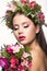 Beautiful girl with a lot of flowers in their hair and bright pink make-up. Spring image. Beauty face.