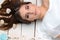 Beautiful girl lying on the floor with seashells in her hair. Portrait. Studio.