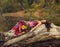 Beautiful girl lying on the tree trunk