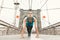 Beautiful girl making stretching at early morning before running. brooklyn bridge and new york skyline in the background