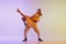 Beautiful girl and man in retro style costumes dancing incendiary dances isolated on gradient lilac color background in