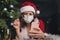 A beautiful girl meets Christmas and New Year through a video call with friends. Quarantine. Self-isolation. Coronavirus