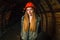 Beautiful girl in a orange helmet in a coal mine. Copy space. Coal Mine Excursion.