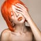 Beautiful girl in an orange wig cosplay style with bright creative lips. Art beauty image.