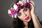 Beautiful girl with perfect skin and bright floral wreath on her head.