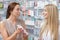 Beautiful girl pharmacist helping a customer