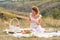 Beautiful girl on a picnic in a picturesque place. Romantic picnic