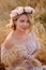 Beautiful girl with pink flowers wreath. Lovely hair and makeup .