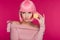 Beautiful girl in pink wig posing with sweet macaron isolated