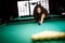 Beautiful girl playing billiards