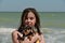 Beautiful girl playing with a dog. Outdoor portrait. series. Girl 11 years old at sea. Vacation and summer concept