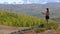 Beautiful girl plays guitar against mountains