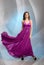 Beautiful girl in plum violet evening dress