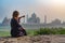 Beautiful girl points to Taj Mahal. Travel concept