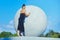 Beautiful girl poses with a large balloon against the sky