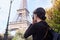 Beautiful girl posing with a camera taking pictures of the Eiffel Tower. Paris, Champ de Mars