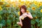 Beautiful girl pours sunflower oil from the jar