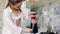 Beautiful girl prepares smoothie in a blender in his kitchen.