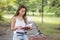 Beautiful girl read book and sit on bicycle