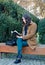 Beautiful girl reading book in the park in spring