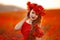 Beautiful girl in red poppy field at sunset. Beuaty makeup. Free