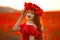 Beautiful girl in red poppy field at sunset. Free Happy Woman En
