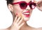 Beautiful girl in red sunglasses with bright makeup and colorful nails. Beauty face.