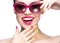 Beautiful girl in red sunglasses with bright makeup and colorful nails. Beauty face.