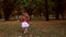 Beautiful girl run in the park. From focus to unfocus