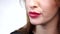 Beautiful girl\'s lower part of face. lips and tongue are sliding over big lollipop. Close up. Slow motion