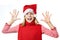 Beautiful girl in Santa hat showing her palms isolated