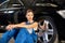 Beautiful girl sits near the black car