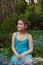 Beautiful girl  sitting in forget me not flowers