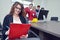 Beautiful girl sitting in office in front of desktop